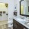 Bathroom with large mirror and adjacent closet