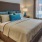 Well lit bedroom with plush carpet